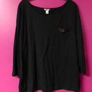 Black 3/4 sleeve shirt. Front has a small pocket.